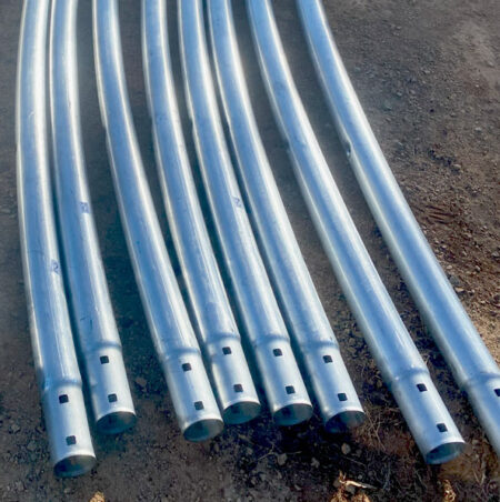 70mm galvanised CHS truss tubes for container dome shelter. Laid out on the ground with female ends showing.