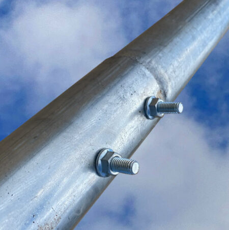 Example of a roof arch round tube connection with carriage bolts and serrated flange nut. These are wrapped with protective tape before installing.