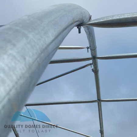 Roof arch truss in place showing interlocking roof purlins and cross bracing tubes.